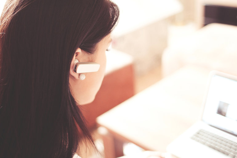Lady With Wireless Headset And Laptop